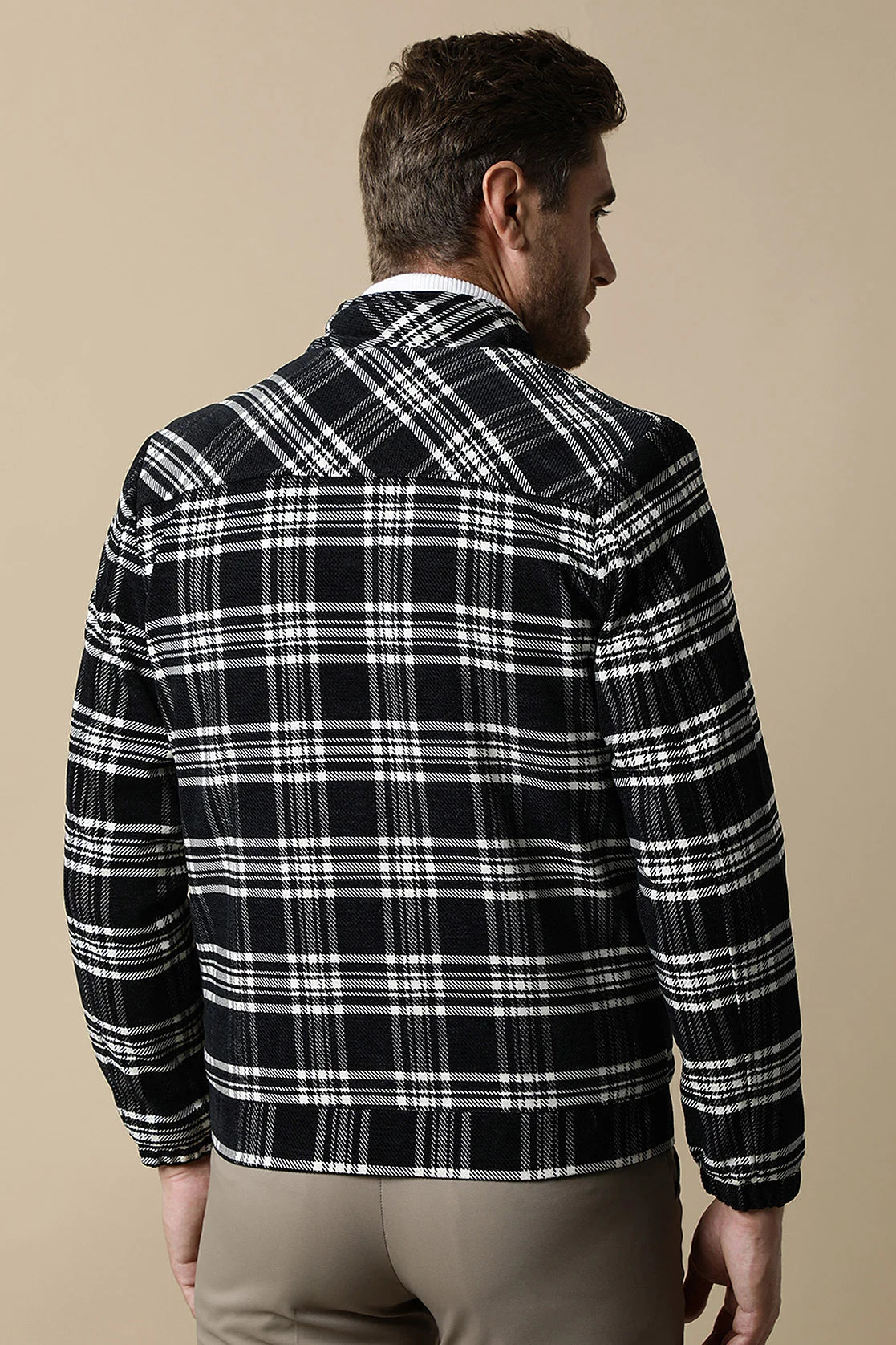 Upgrade your wardrobe with the Fort Collins Men's Black Tweed Plaid Jacket featuring a quilted lining. Shop now online from anywhere in India for a stylish addition to your wardrobe