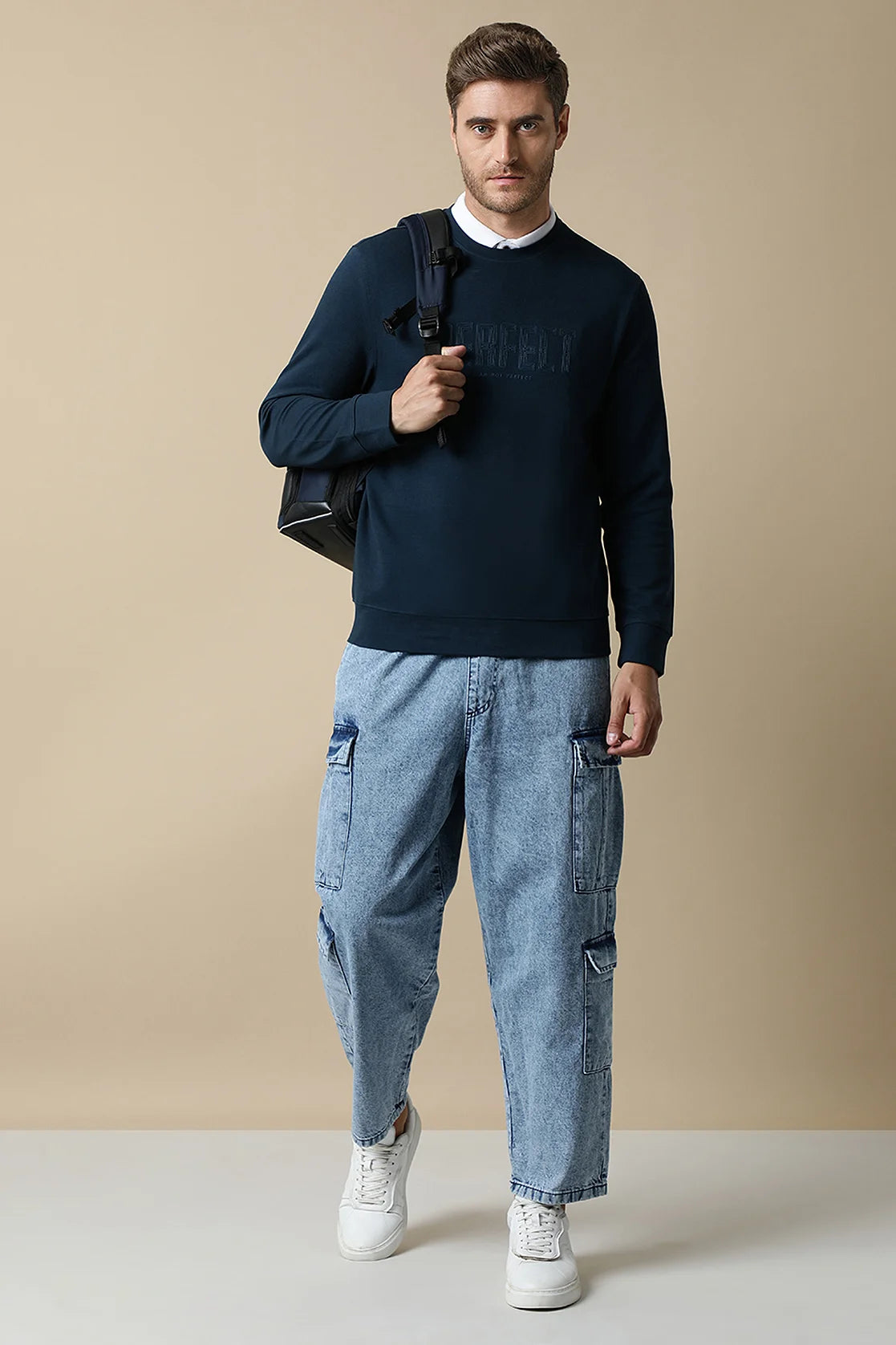 Elevate your style with the Fort Collins Men's Dark Blue Round Neck Sweatshirt, featuring a chic embossed chest print. Available for online purchase from anywhere in India.