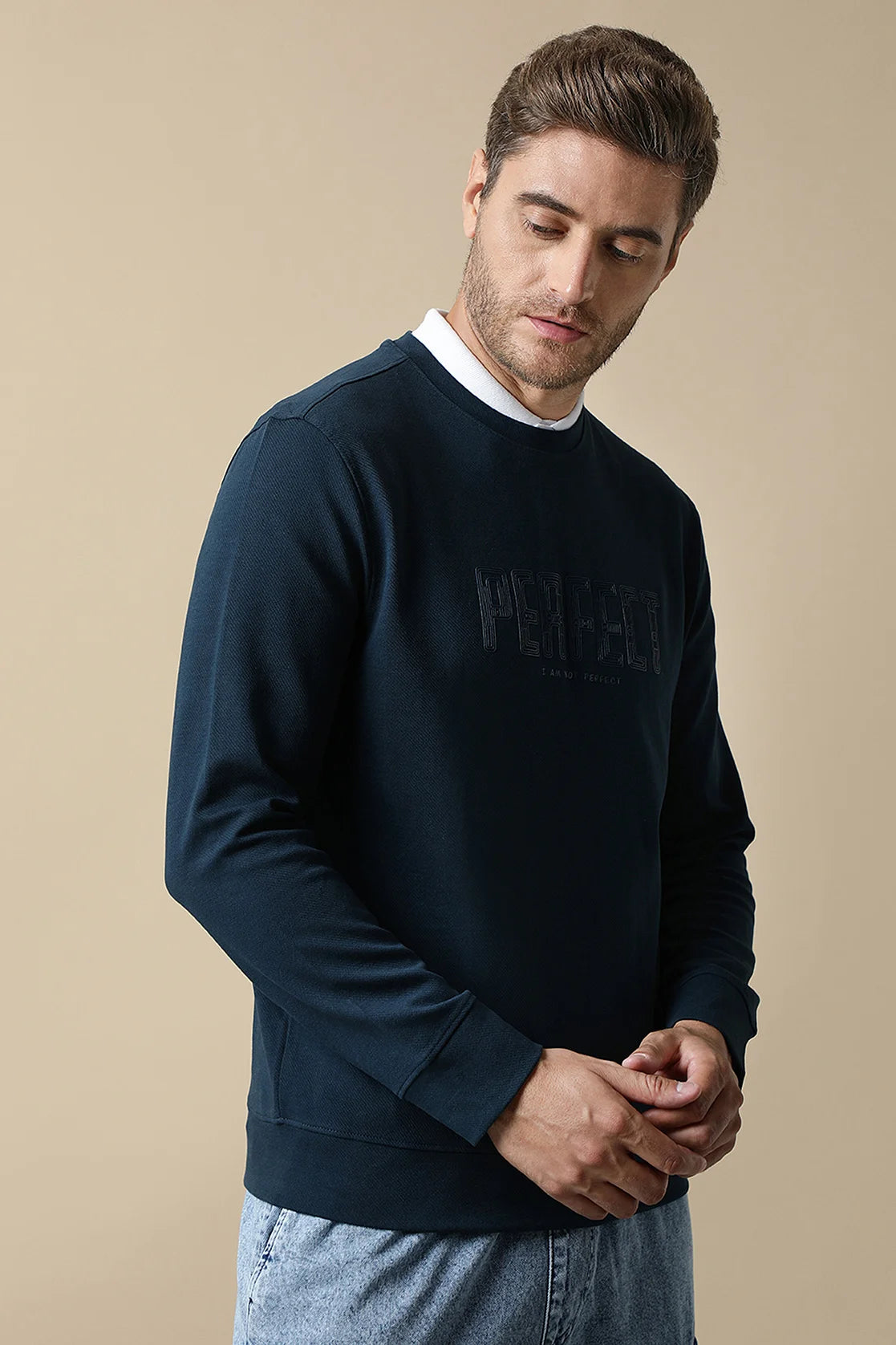 Discover the stylish Fort Collins Men's Dark Blue Round Neck Sweatshirt with Embossed Chest Print, available online for purchase in India. Upgrade your wardrobe with this trendy option today.