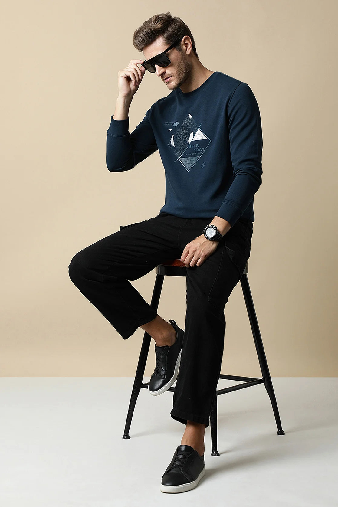 Upgrade your wardrobe with the men's dark blue round neck sweatshirt featuring an embossed graphic, available now on Fort Collins. Discover the latest trends and shop conveniently from anywhere in India.