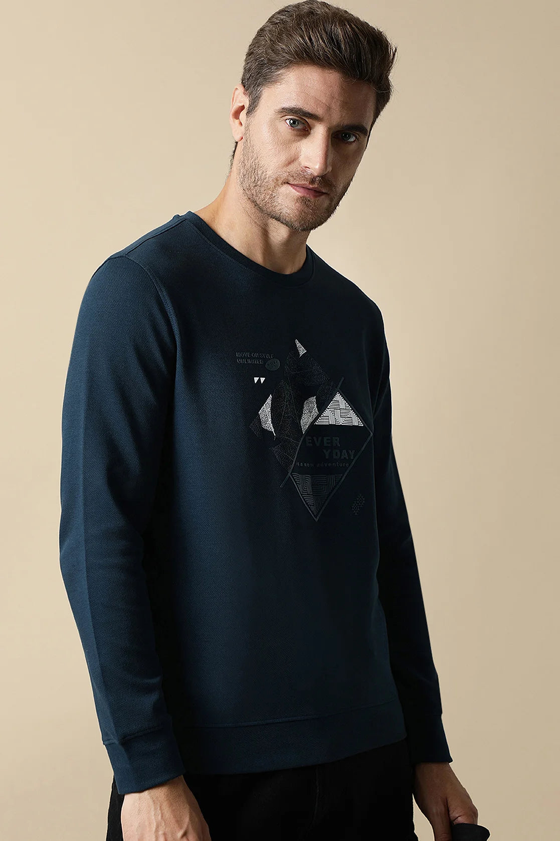 Explore the stylish Men's Dark Blue Round Neck Sweatshirt with Embossed Graphic, brought to you by Fort Collins. Enhance your wardrobe with this trendy and versatile piece, available for purchase from anywhere in India.