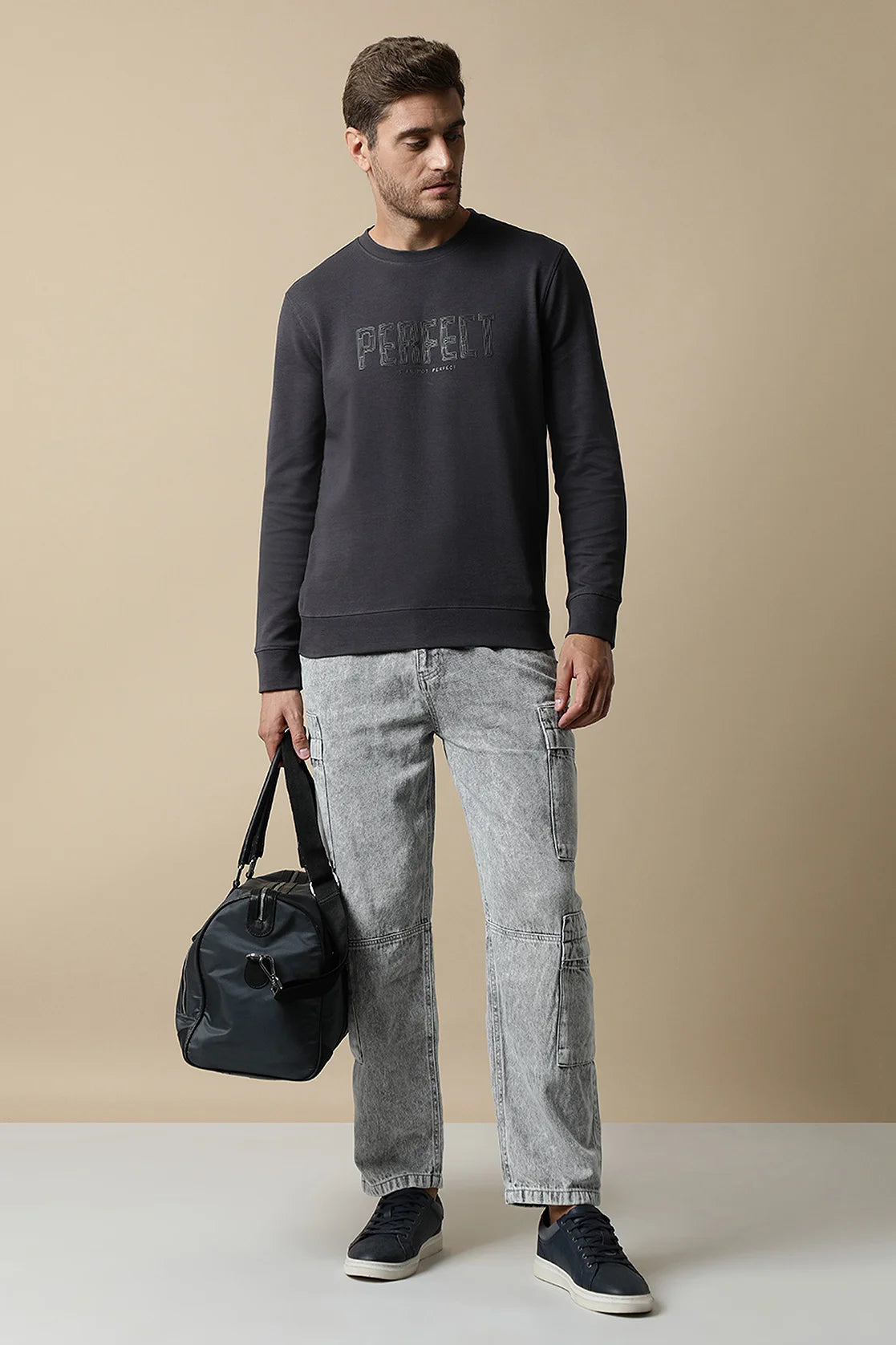 Discover a stylish addition to your wardrobe with the Men's Dark Grey Round Neck Sweatshirt featuring an Embossed Chest Print by Fort Collins. Purchase now on our online store and elevate your fashion game from the comfort of your home.