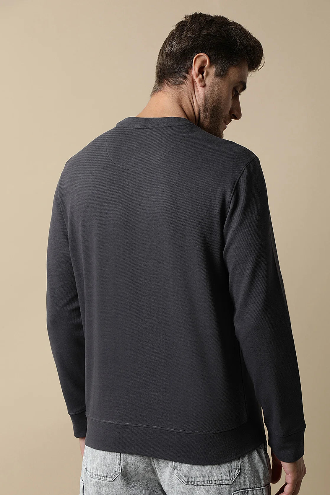 Shop for a stylish wardrobe with the Men's Dark Grey Round Neck Sweatshirt with Embossed Chest Print by Fort Collins. Available online for purchase anywhere in India.