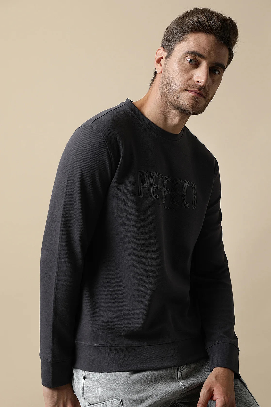 Explore Men's Dark Grey Round Neck Sweatshirt with Embossed Chest Print By Fort Collins on our website, available for purchase from anywhere in India. Increase your style quotient with this must-have wardrobe staple.