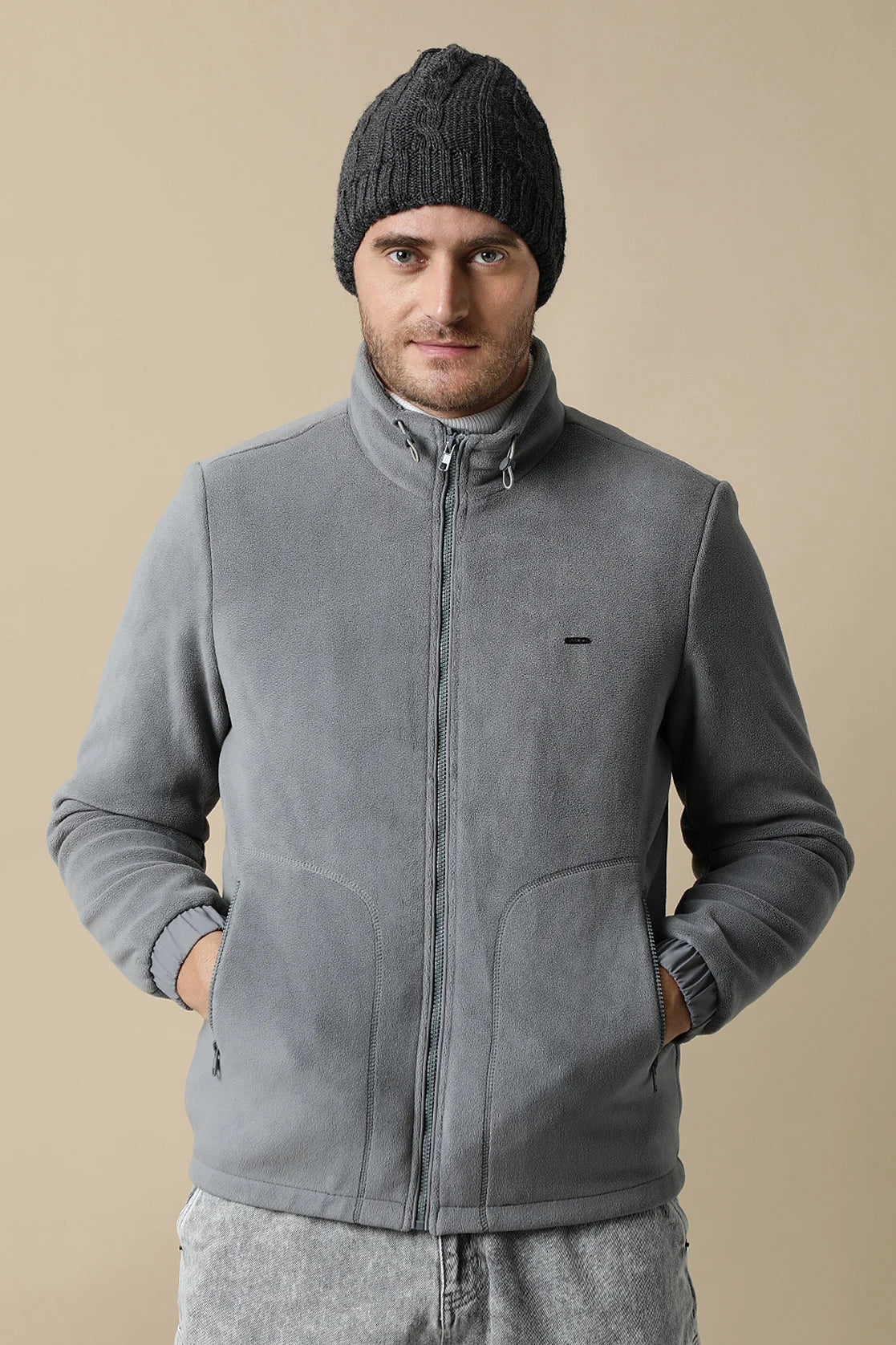 Elevate your style with the Fort Collins Men's Grey Fleece Jacket, featuring a convenient zip-up front. This versatile wardrobe staple is available for online purchase throughout India.