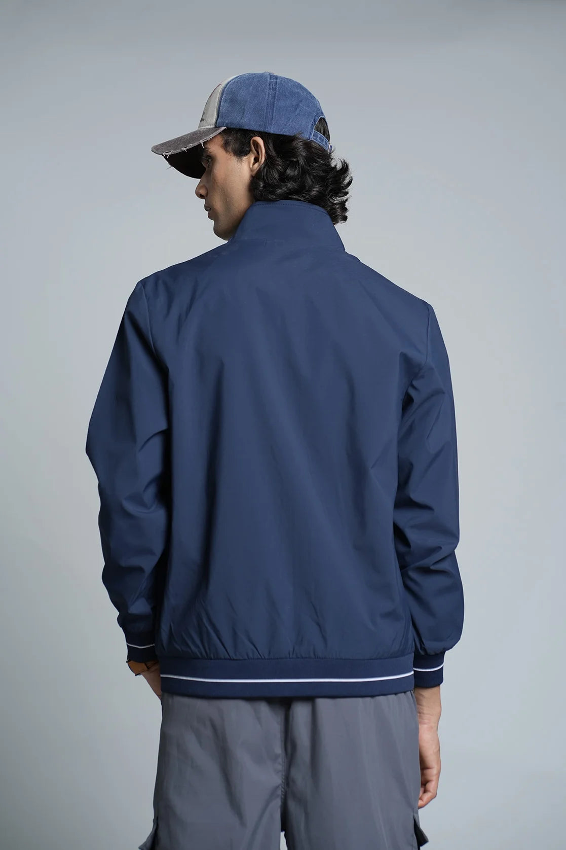 Upgrade your wardrobe with the Men's Navy Blue Lightweight Windbreaker Jacket from Fort Collins. Available for purchase anywhere in India for a stylish addition to your closet.