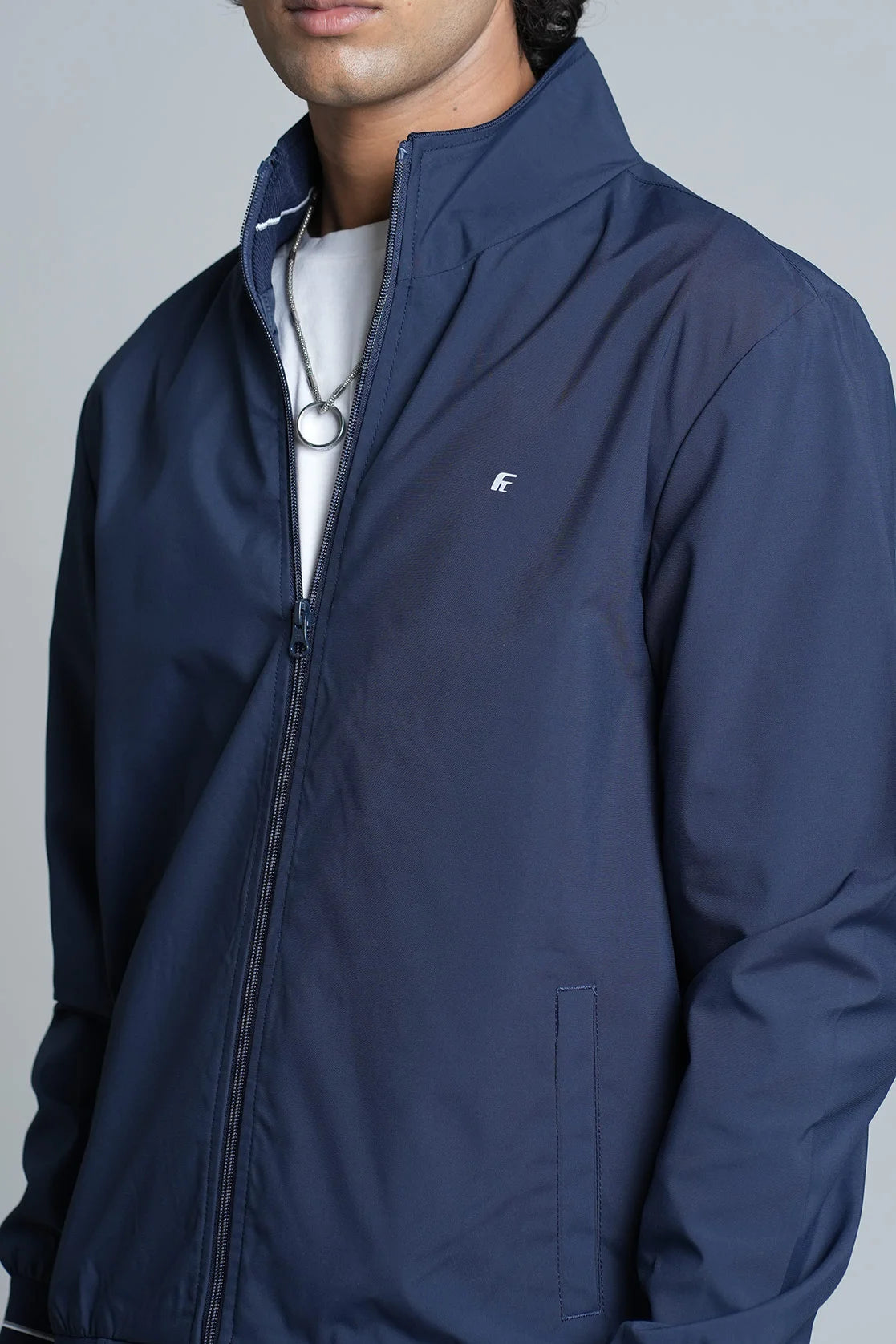 Enhance your wardrobe with the Men's Navy Blue Lightweight Windbreaker Jacket from Fort Collins. Available for purchase online in India for a fashionable and practical addition to your clothing collection.