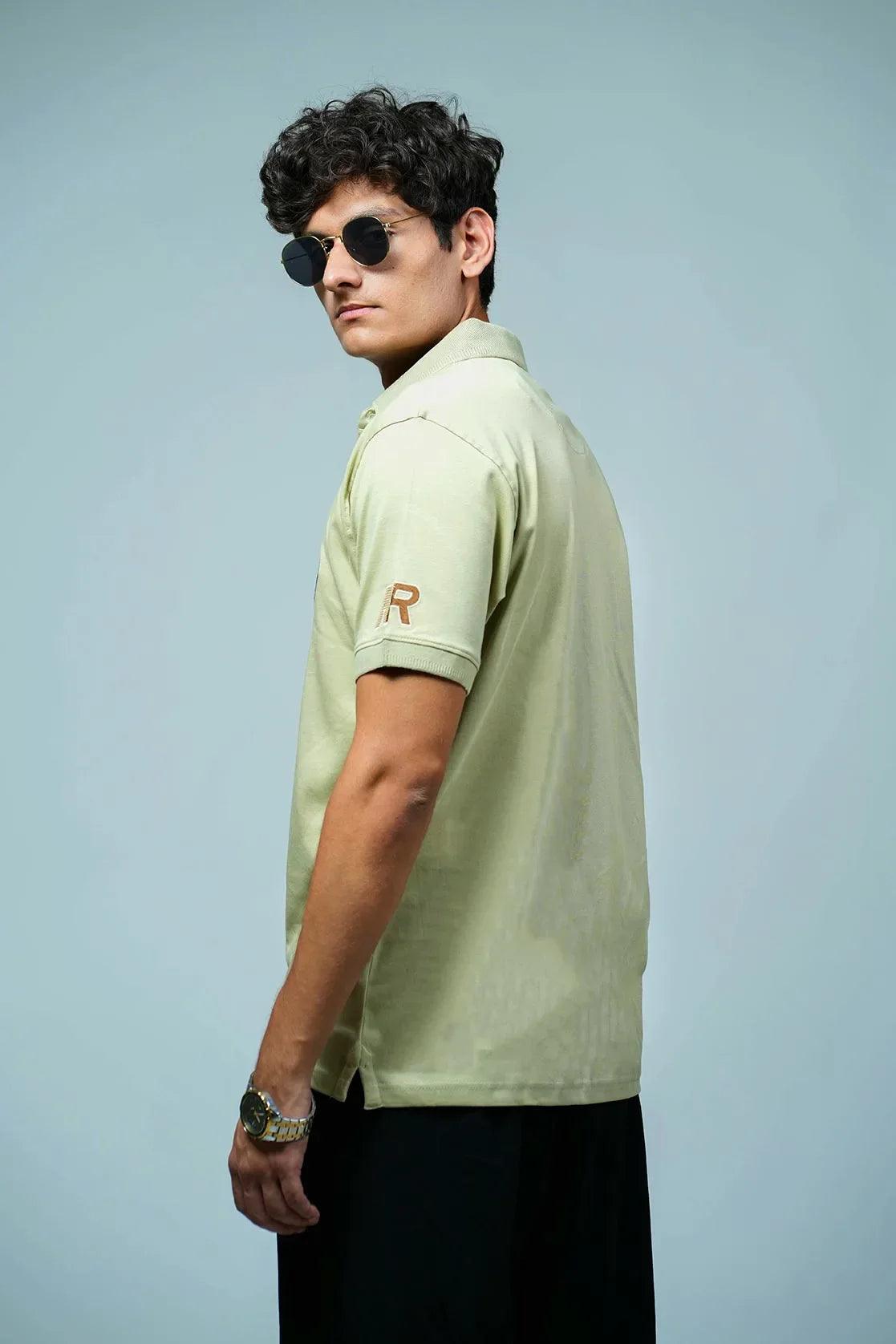 This Men's Light Green Front Button Polo Collar T-Shirt features embroidery patches and is designed by the renowned brand Fort Collins.