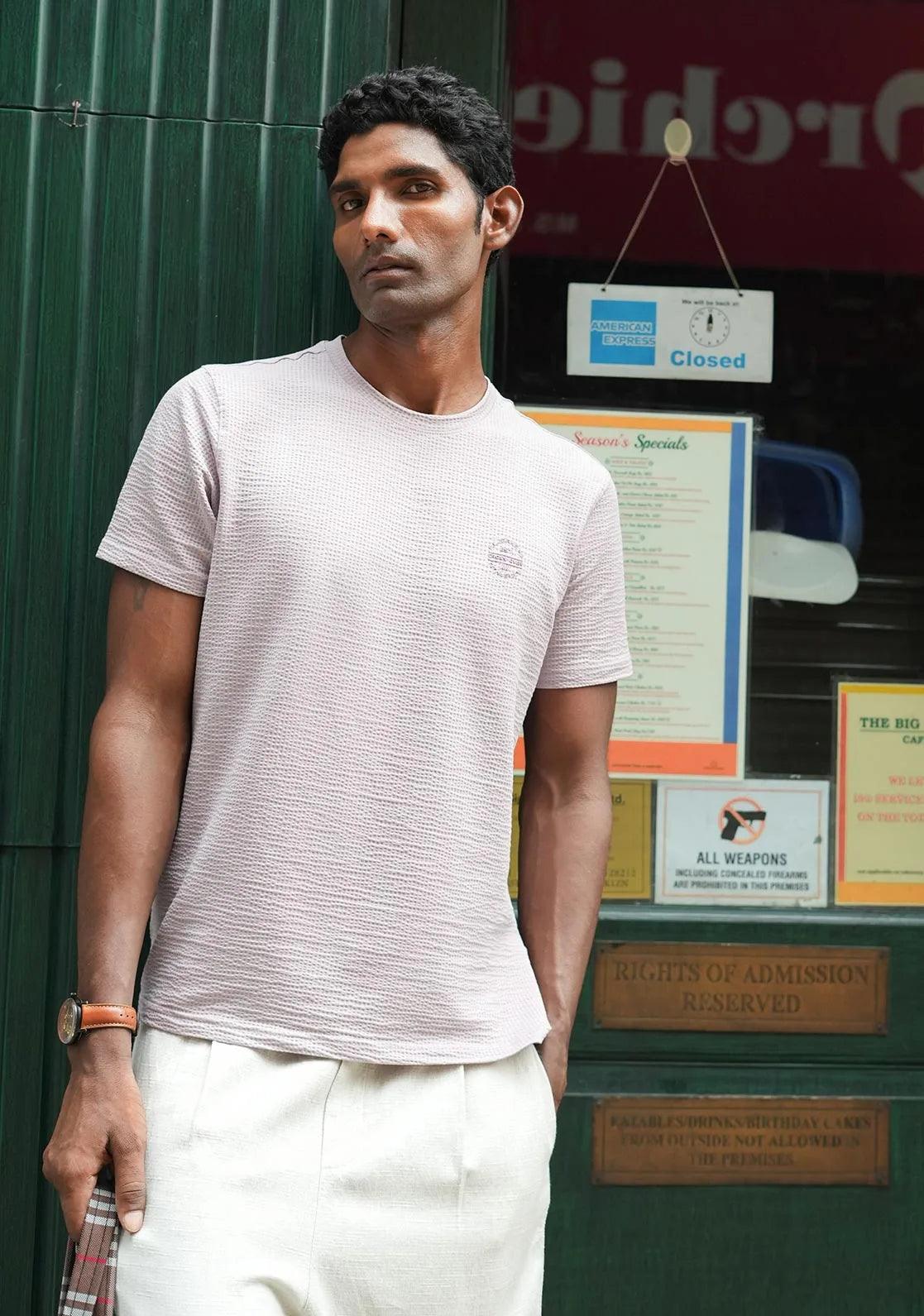 This Men's T-Shirt combines a structured fabric with a solid lavender color and features a round neck and a chest logo, all designed by Fort Collins.