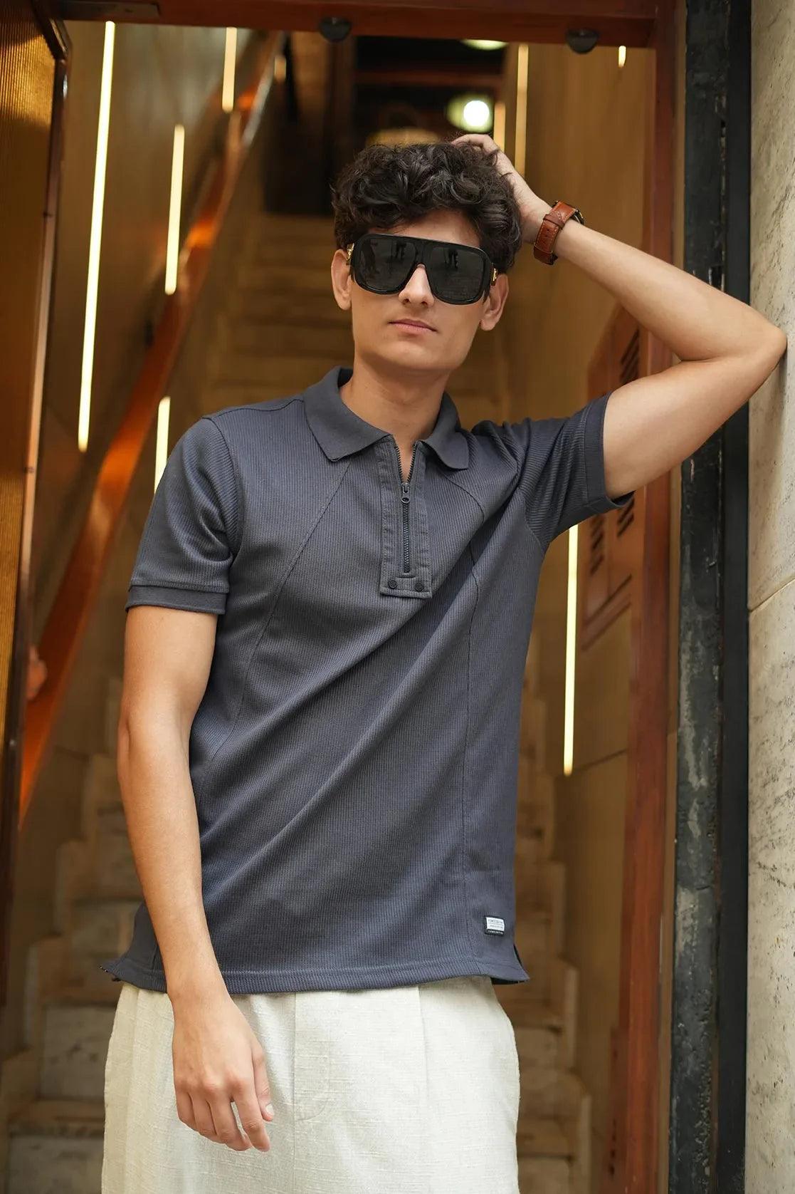 This Men's Dark Grey Polo Collar T-Shirt by Fort Collins features a stylish design and a convenient zippered placket, making it both functional and fashionable.