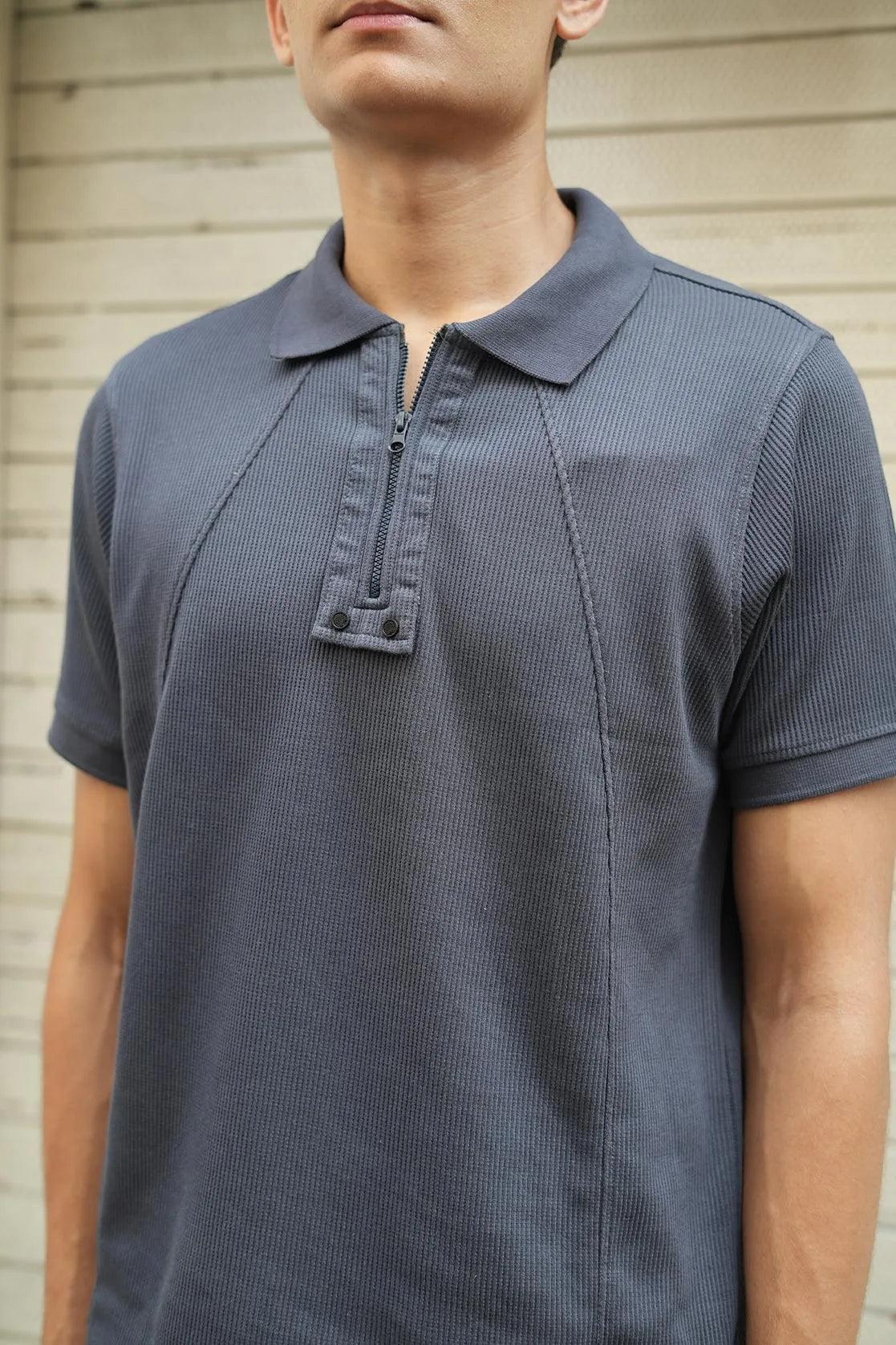 Expertly crafted for the modern man, this Men's Dark Grey Solid Polo Collar T-Shirt features a sleek zippered placket and stylish design, making it a versatile and must-have addition to any wardrobe.