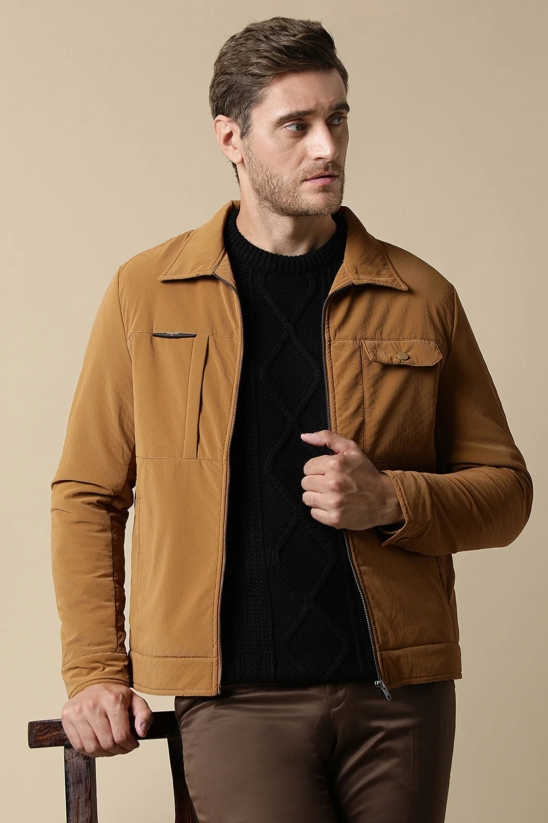 Discover the sleek and timeless design of this Men's Tan PU Coated Jacket, featuring a classic front zipper. Elevate your wardrobe with the Beige Stretchable T-Shirt, complete with a New York Graphic Print.