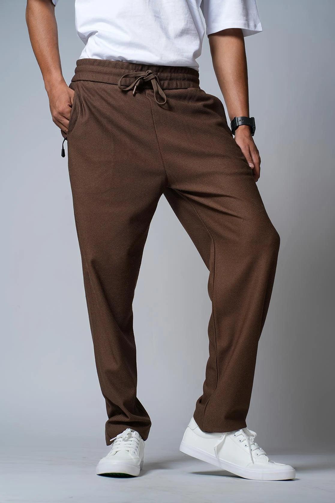 Discover the sleek and functional Men's Tan Regular Fit Track Pants, featuring convenient zipper pockets. Perfect for any active lifestyle, these pants are available online in India from Fort Collins.