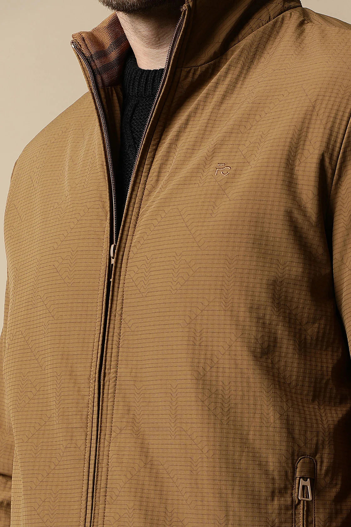 The Men's Tan Textured Lightweight Jacket by Fort Collins offers a stylish wardrobe upgrade, available to purchase online from anywhere in India.