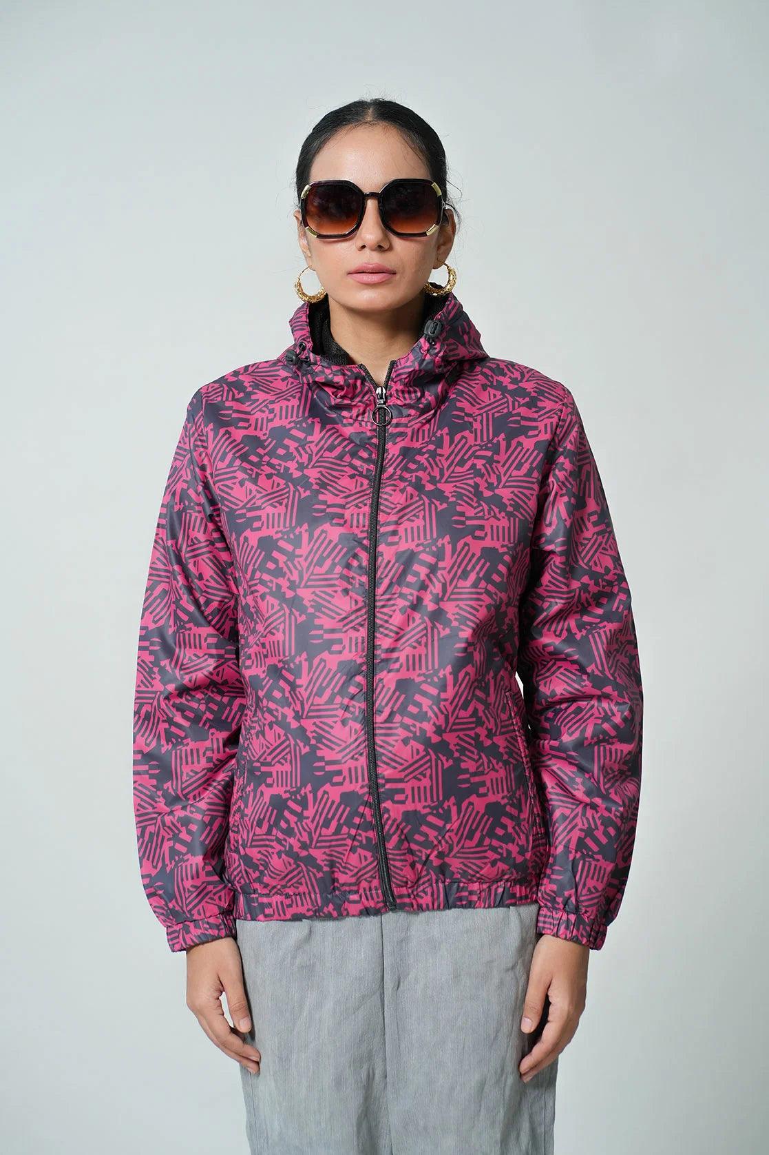 Experience the stylish and functional Women's Red Abstract Printed Windbreaker Jacket with an adjustable hood, available online in India. Incorporating cutting-edge design and features, this jacket is perfect for any fashion-savvy individual looking for a high-quality, versatile addition to their wardrobe.