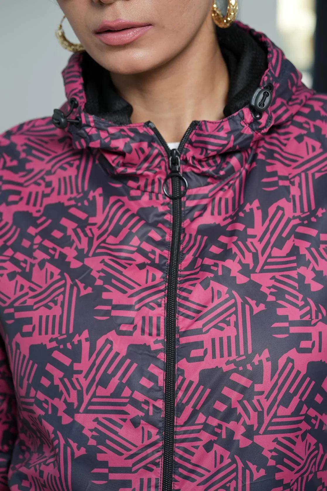 Discover the versatile Women's Red Abstract Printed Windbreaker Jacket from Fort Collins, now available online in India. Featuring an adjustable hood and a unique abstract print, this jacket is perfect for all your outdoor activities.