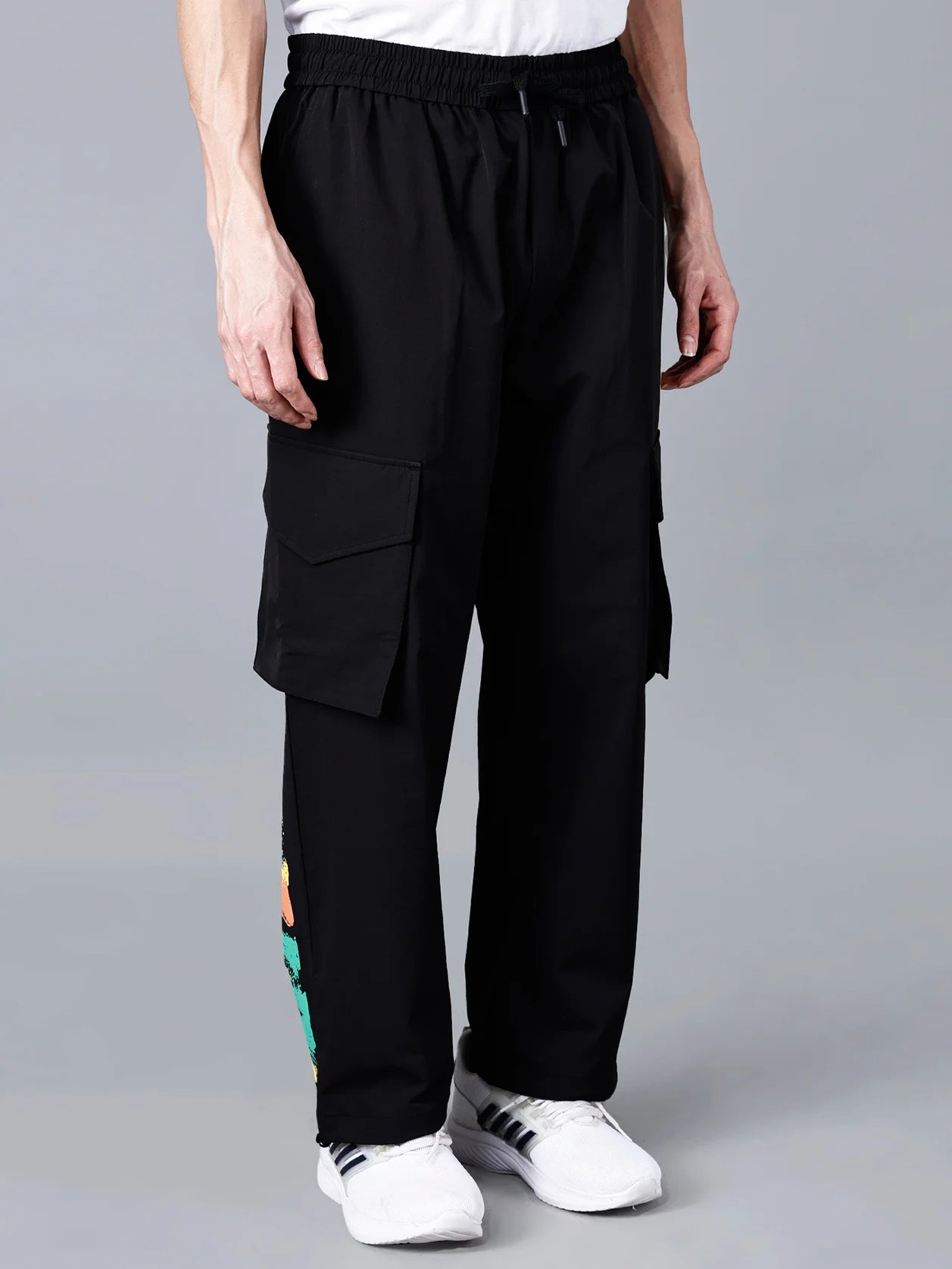 Discover black cargo track pants for men with Y-3 yellow patch and multicolor brushstroke print, stylish relaxed fit pants ideal for gym, travel, and streetwear fashion. Shop now online in India with us. We ship across India.