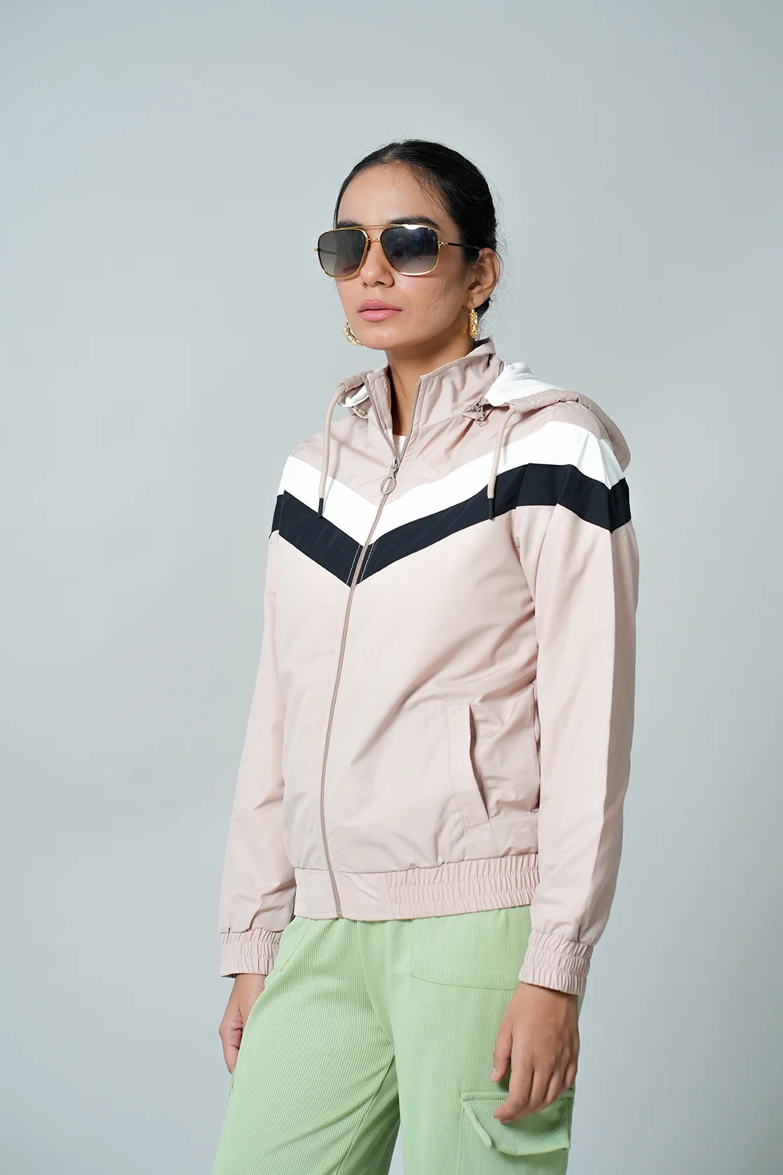 Enhance your wardrobe with this stylish Women's Beige Chevron Windbreaker Jacket from Fort Collins. Stay protected from the wind and rain with the adjustable hood. Shop now online from anywhere in India.