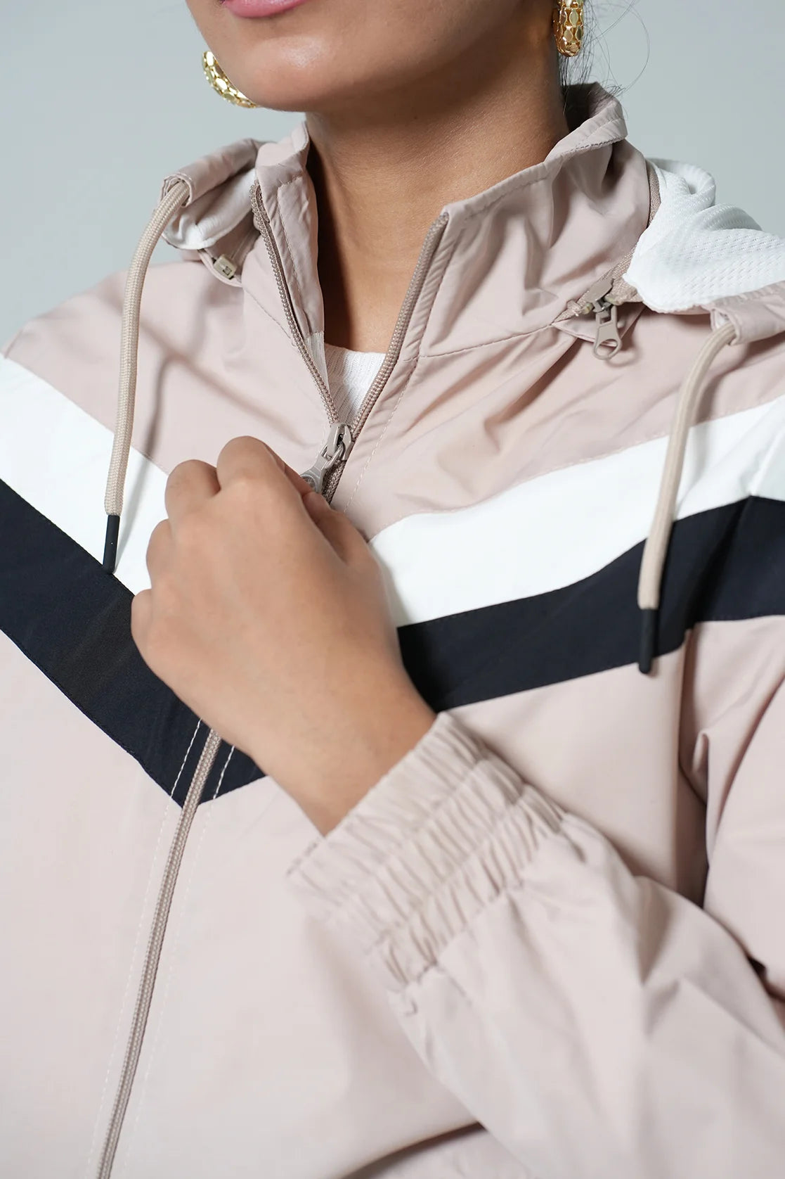 Upgrade your wardrobe with the Fort Collins Women's Beige Chevron Windbreaker Jacket, featuring an adjustable hood. Shop now online to stay on trend from anywhere in India.