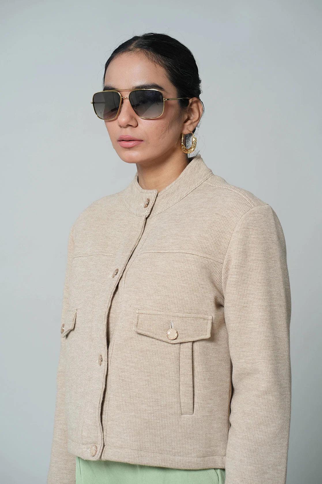 Upgrade your wardrobe with the Fort Collins Women's Beige Short Length Knitted Jacket. This trendy and stylish piece features a classic button closure and is available for purchase online from anywhere in India.