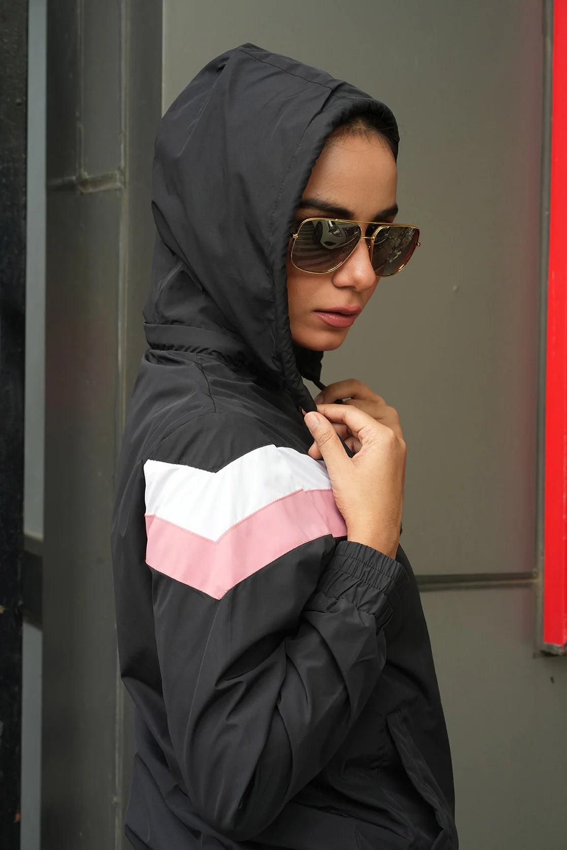 Upgrade your wardrobe with the stylish Women's Black Chevron Windbreaker Jacket with Adjustable Hood, now available for purchase online from anywhere in India. Don't miss this trendy addition!