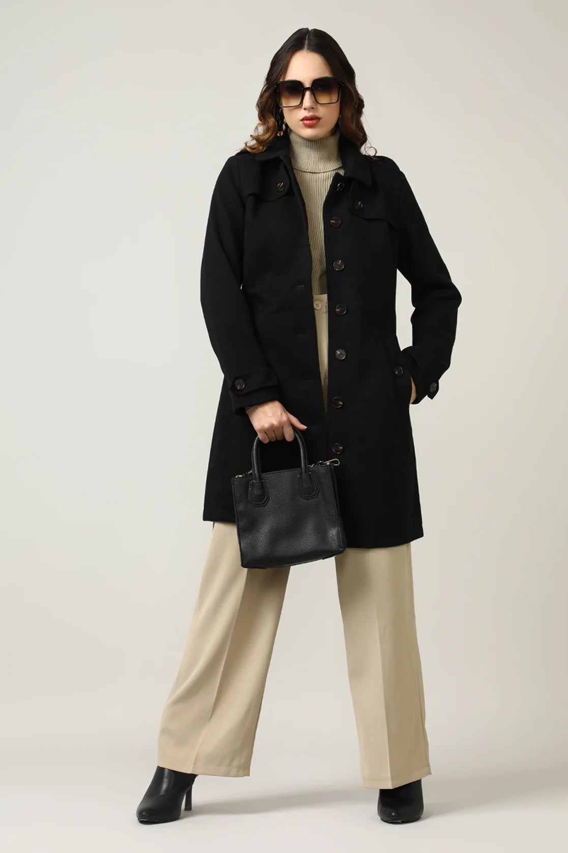 Experience the timeless elegance and sophistication of our Women's Black Tweed Fabric Trench Coat by Fort Collins. Available for purchase online from anywhere in India.