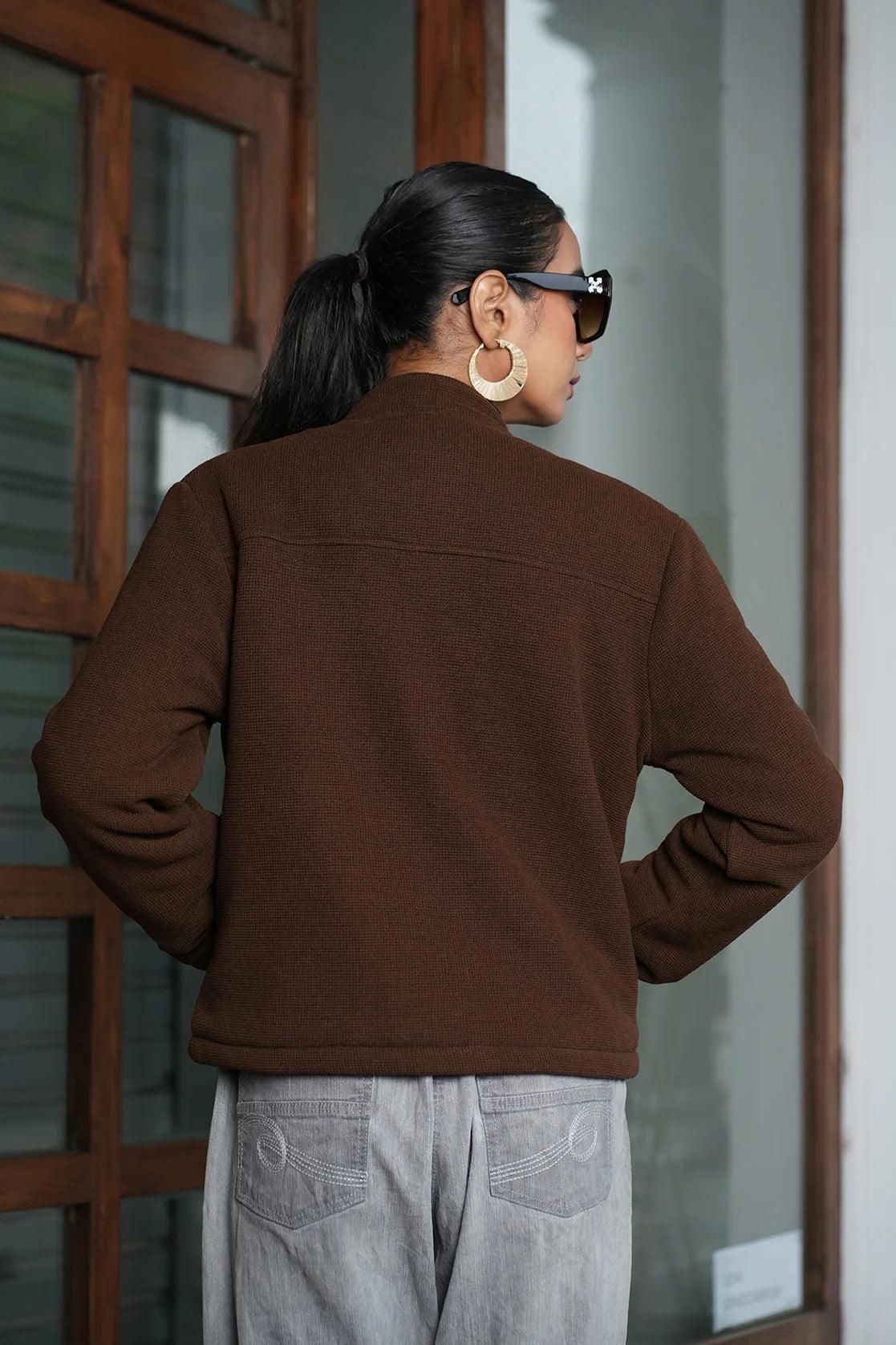 This women's brown short length knitted jacket features a button closure and is available for purchase online in India.