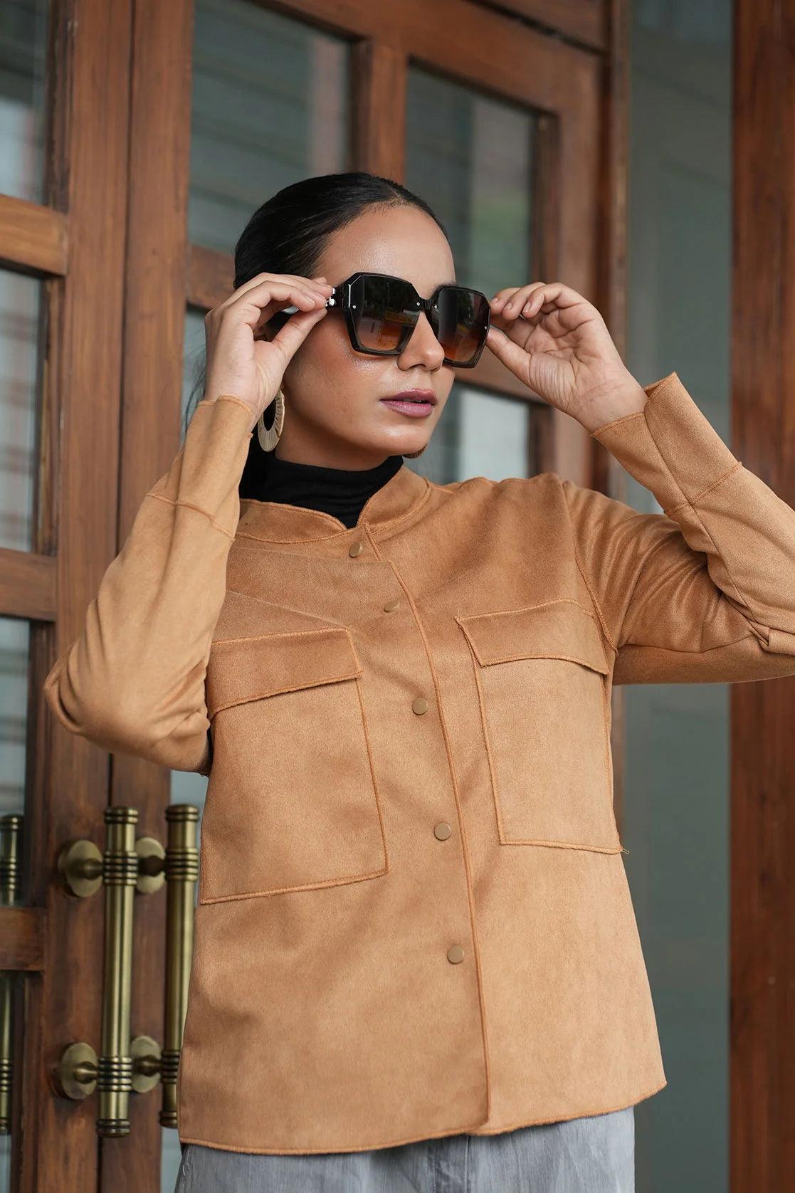 Upgrade your wardrobe with the Tan Suede Shacket for Women from Fort Collins. Featuring dual chest pockets, this trendy piece can be easily purchased online from anywhere in India.