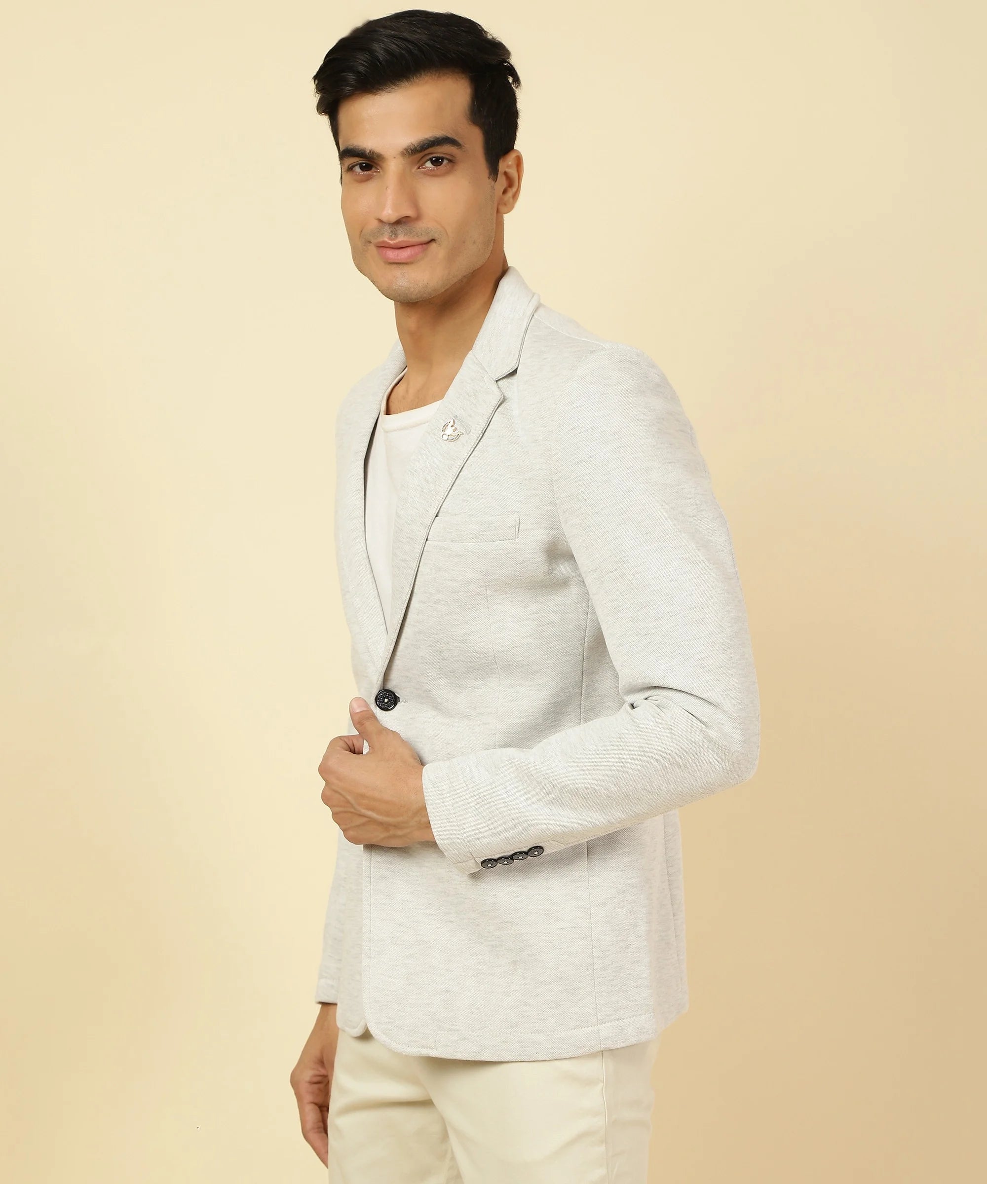 Shop now for a trendy wardrobe from anywhere in India with Men's Off White Knitted Blazer by Fort Collins, featuring a notched lapel.